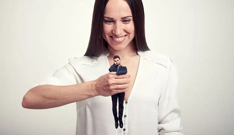 Woman holding a miniature man