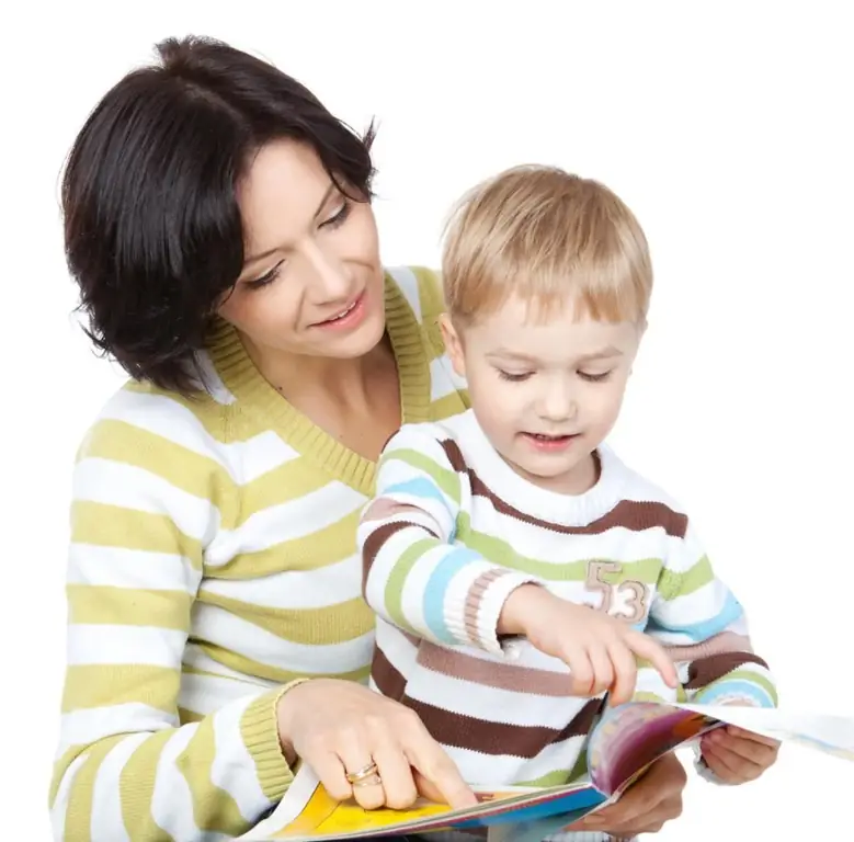 mother showing her son a book