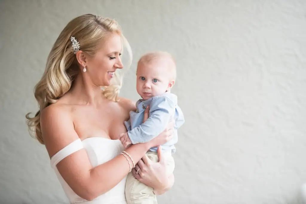 bride holding baby in her arms