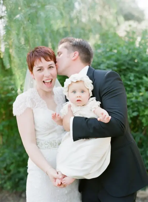 bride and groom with child