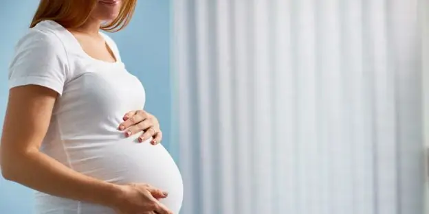 Pregnant woman in white t-shirt