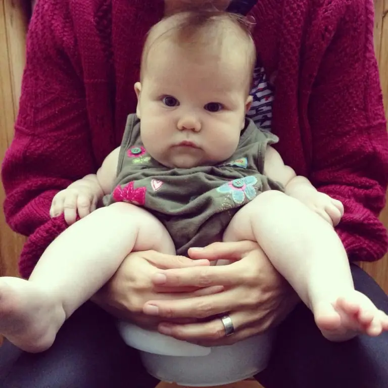 baby held over potty